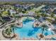 Overhead view of community pool with splash park, mature palms and blue sky at 21797 Briske Morning Ave, Land O Lakes, FL 34637