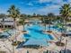 Aerial view of the luxurious community pool with palm trees, splash pad, and lounge seating at 21797 Briske Morning Ave, Land O Lakes, FL 34637