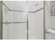 Contemporary shower with a glass door, white tiling, and a decorative mosaic accent at 21797 Briske Morning Ave, Land O Lakes, FL 34637