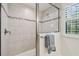 Beautiful tiled shower enclosure with a glass door, window and towel rack at 21797 Briske Morning Ave, Land O Lakes, FL 34637