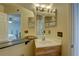 Bright bathroom with updated vanity, natural light, and a view into the adjacent bedroom at 2500 Winding Creek Blvd # G307, Clearwater, FL 33761