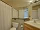 The bathroom features a shower-tub combination and an updated vanity with a view into the bedroom at 2500 Winding Creek Blvd # G307, Clearwater, FL 33761