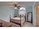 Relaxing bedroom featuring a ceiling fan, soft lighting, and a full sized mirror at 2500 Winding Creek Blvd # G307, Clearwater, FL 33761