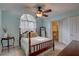 Comfortable bedroom featuring a ceiling fan, natural light, and an ensuite bathroom at 2500 Winding Creek Blvd # G307, Clearwater, FL 33761