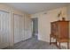 Bedroom offering ample closet space, modern floors and a vintage-style wooden hutch at 2500 Winding Creek Blvd # G307, Clearwater, FL 33761