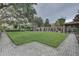 Well-maintained community area with green lawn, brick structures, and comfortable seating at 2500 Winding Creek Blvd # G307, Clearwater, FL 33761