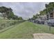 Community dog park running adjacent to parking with well-maintained fencing and green spaces at 2500 Winding Creek Blvd # G307, Clearwater, FL 33761