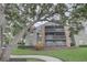 Spacious condo with multiple screened balconies, brick accents, and lush landscaping at 2500 Winding Creek Blvd # G307, Clearwater, FL 33761