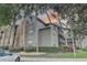 Condo with brick and siding exterior, complemented by manicured landscaping, trees, and adjacent parking at 2500 Winding Creek Blvd # G307, Clearwater, FL 33761