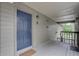 Exterior view of the front door with gray wood panels and a blue door to unit G307 at 2500 Winding Creek Blvd # G307, Clearwater, FL 33761