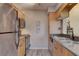 Functional kitchen featuring stainless steel appliances, light wood cabinets, and a granite countertop at 2500 Winding Creek Blvd # G307, Clearwater, FL 33761