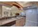 Well-lit kitchen features a stainless steel sink and countertop, with a view to the dining and living areas at 2500 Winding Creek Blvd # G307, Clearwater, FL 33761