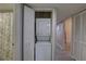 Compact laundry closet featuring a stacked washer and dryer unit for added convenience at 2500 Winding Creek Blvd # G307, Clearwater, FL 33761