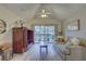 Cozy living room features a ceiling fan and sliding glass doors to a private balcony at 2500 Winding Creek Blvd # G307, Clearwater, FL 33761
