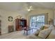 Cozy living room with a ceiling fan, sofa, and sliding glass doors opening to a private balcony at 2500 Winding Creek Blvd # G307, Clearwater, FL 33761