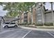 Convenient covered parking near the condo building with landscaped pathways and mature trees at 2500 Winding Creek Blvd # G307, Clearwater, FL 33761