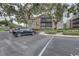 Designated parking area for a condo building, with mature trees and well-kept landscaping at 2500 Winding Creek Blvd # G307, Clearwater, FL 33761