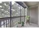 Screened-in patio featuring wood floors, ample natural light, and decorated with potted plants at 2500 Winding Creek Blvd # G307, Clearwater, FL 33761