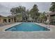 Inviting community pool with lounge chairs and shaded seating areas amidst mature landscaping at 2500 Winding Creek Blvd # G307, Clearwater, FL 33761