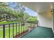 Open air balcony with outdoor carpet overlooking lush landscaping and green lawns at 2699 Seville Blvd # 207, Clearwater, FL 33764