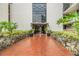 The grand entrance with brick walkway, tropical plants and stone accents at 2699 Seville Blvd # 207, Clearwater, FL 33764