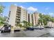 Condo building with balconies, guest parking, and well maintained landscaping at 2699 Seville Blvd # 207, Clearwater, FL 33764