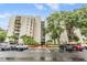 Beautiful condo building featuring lush landscaping, ample parking, and a grand entrance at 2699 Seville Blvd # 207, Clearwater, FL 33764