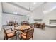 Bright community room featuring tables, chairs, and a white brick fireplace for comfortable gatherings at 2699 Seville Blvd # 207, Clearwater, FL 33764