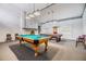A game room with pool and card tables, a fireplace, and modern lighting that is perfect for entertaining at 2699 Seville Blvd # 207, Clearwater, FL 33764