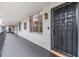 Hallway with a unit entrance and secure metal security door at 2699 Seville Blvd # 207, Clearwater, FL 33764