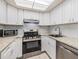 Updated kitchen featuring stainless steel appliances, granite counters, and ample cabinet space at 2699 Seville Blvd # 207, Clearwater, FL 33764