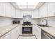 Bright kitchen featuring white cabinetry, modern appliances, and stylish countertop finishes at 2699 Seville Blvd # 207, Clearwater, FL 33764