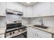 Modern kitchen offering stainless steel appliances, granite countertops, and white subway tile at 2699 Seville Blvd # 207, Clearwater, FL 33764