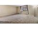 Spacious living room features soft carpet and a large window with natural light at 2699 Seville Blvd # 207, Clearwater, FL 33764
