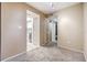 Cozy living room featuring neutral tones and plush carpeting throughout the home at 2699 Seville Blvd # 207, Clearwater, FL 33764