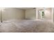 Bright and airy living room with neutral carpet and natural light at 2699 Seville Blvd # 207, Clearwater, FL 33764