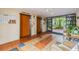 A welcoming lobby area features elevators, tiled floors and tranquil view of tropical landscaping at 2699 Seville Blvd # 207, Clearwater, FL 33764