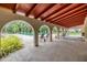 Covered patio area overlooking the pool with lounge chairs and a red tin roof at 2699 Seville Blvd # 207, Clearwater, FL 33764