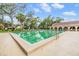 Well-maintained pool with lush landscaping and comfortable lounge chairs available for residents at 2699 Seville Blvd # 207, Clearwater, FL 33764
