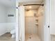 Bright bathroom featuring a walk-in shower with tiled walls and an updated shower head fixture at 27466 Tierra Del Fuego Cir, Punta Gorda, FL 33983