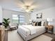 Well-lit bedroom with large window, ceiling fan, and modern decor with white accents at 27466 Tierra Del Fuego Cir, Punta Gorda, FL 33983