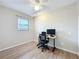 Bright bedroom with a wood-look floor, a modern ceiling fan, and a work-from-home setup at 27466 Tierra Del Fuego Cir, Punta Gorda, FL 33983