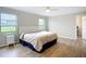 Cozy bedroom with hardwood floors, natural light, and a ceiling fan at 27466 Tierra Del Fuego Cir, Punta Gorda, FL 33983