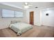 Simple bedroom featuring a ceiling fan, a window with blinds, and a closet with louvered doors at 27466 Tierra Del Fuego Cir, Punta Gorda, FL 33983