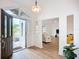 Bright foyer with open front door and wood-look flooring leading to living room at 27466 Tierra Del Fuego Cir, Punta Gorda, FL 33983