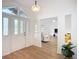 Bright foyer features a decorative glass front door, modern light fixture, and wood-look flooring at 27466 Tierra Del Fuego Cir, Punta Gorda, FL 33983