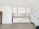 Garage wall features built-in cabinets and workspace, ready for projects and organization in an unfinished garage at 27466 Tierra Del Fuego Cir, Punta Gorda, FL 33983