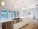 Spacious kitchen with stainless steel appliances, shaker cabinets, and views to the backyard pool at 27466 Tierra Del Fuego Cir, Punta Gorda, FL 33983
