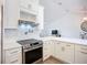 Close-up of modern kitchen with stainless steel oven and white backsplash at 27466 Tierra Del Fuego Cir, Punta Gorda, FL 33983