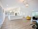 Bright, open-concept layout with hardwood floors connecting the kitchen, with a long island, to the living room at 27466 Tierra Del Fuego Cir, Punta Gorda, FL 33983
